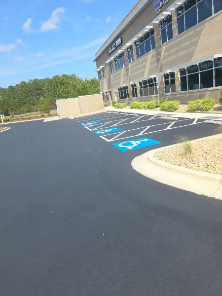ADA parking lot striping contractors marking accessible spaces at a Charlotte NC retail center