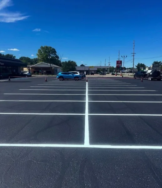 Fresh white stall lines on a newly sealed commercial parking lot in Charlotte NC