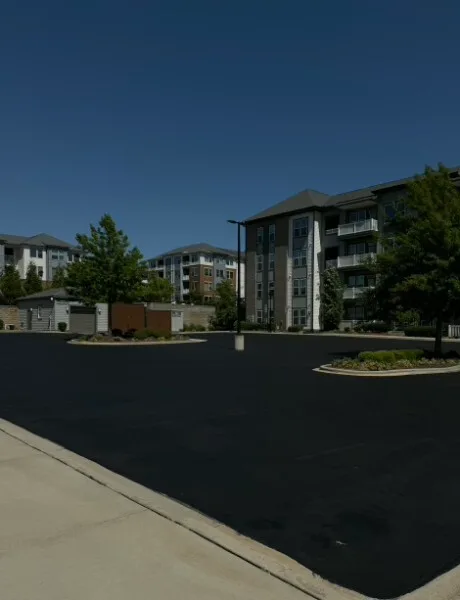 Freshly sealcoated multifamily parking lot with landscaped islands at a Charlotte NC apartment community