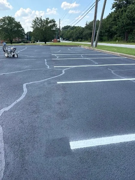 Hot-pour crack filling and fresh stall striping on a commercial parking lot in Charlotte NC