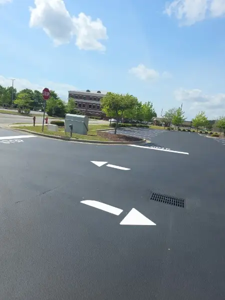 Parking lot stenciling and directional arrow markings applied at a Charlotte NC shopping center