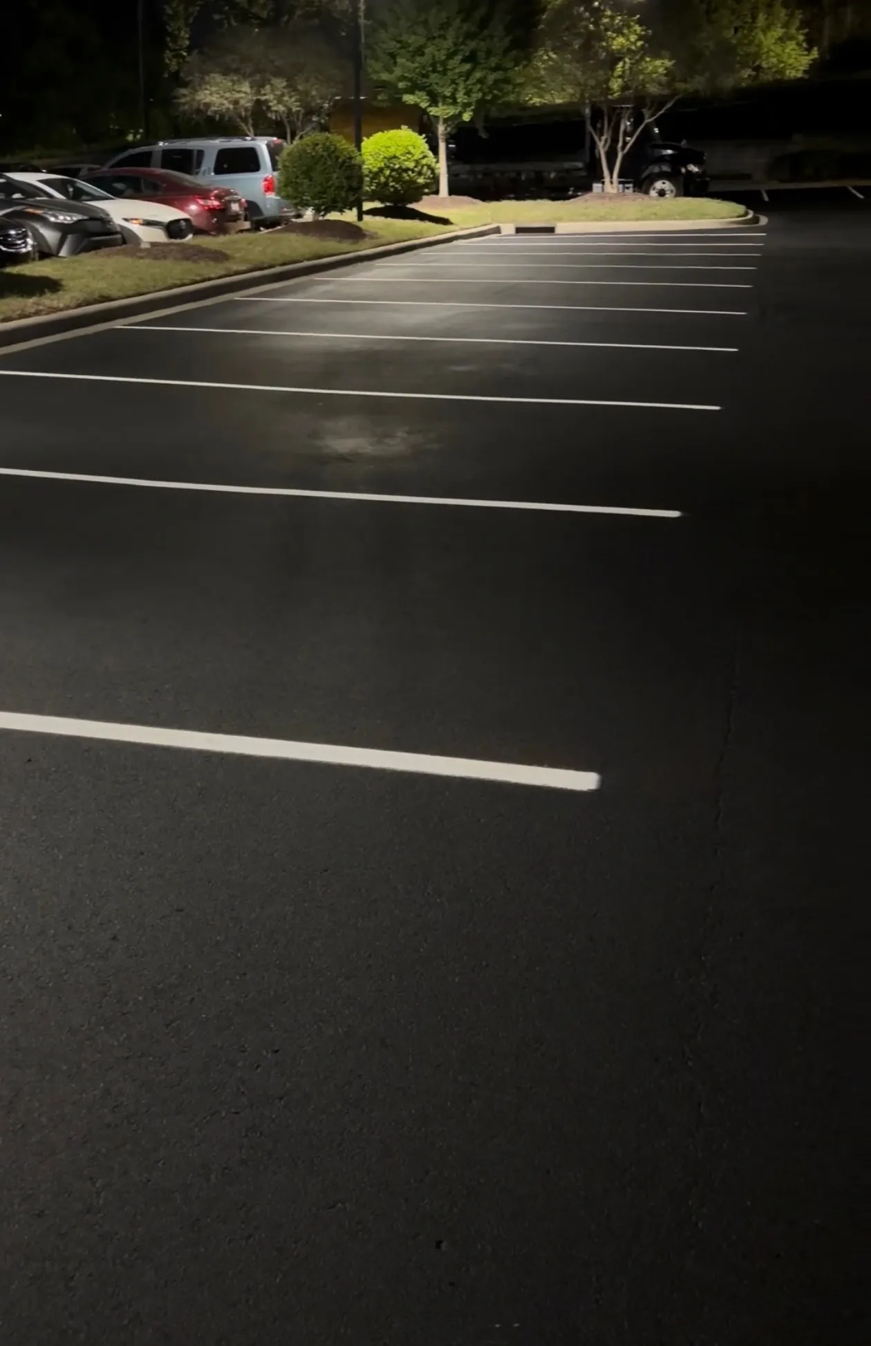 Reflective parking lot striping paint improving nighttime visibility at a Charlotte NC retail center