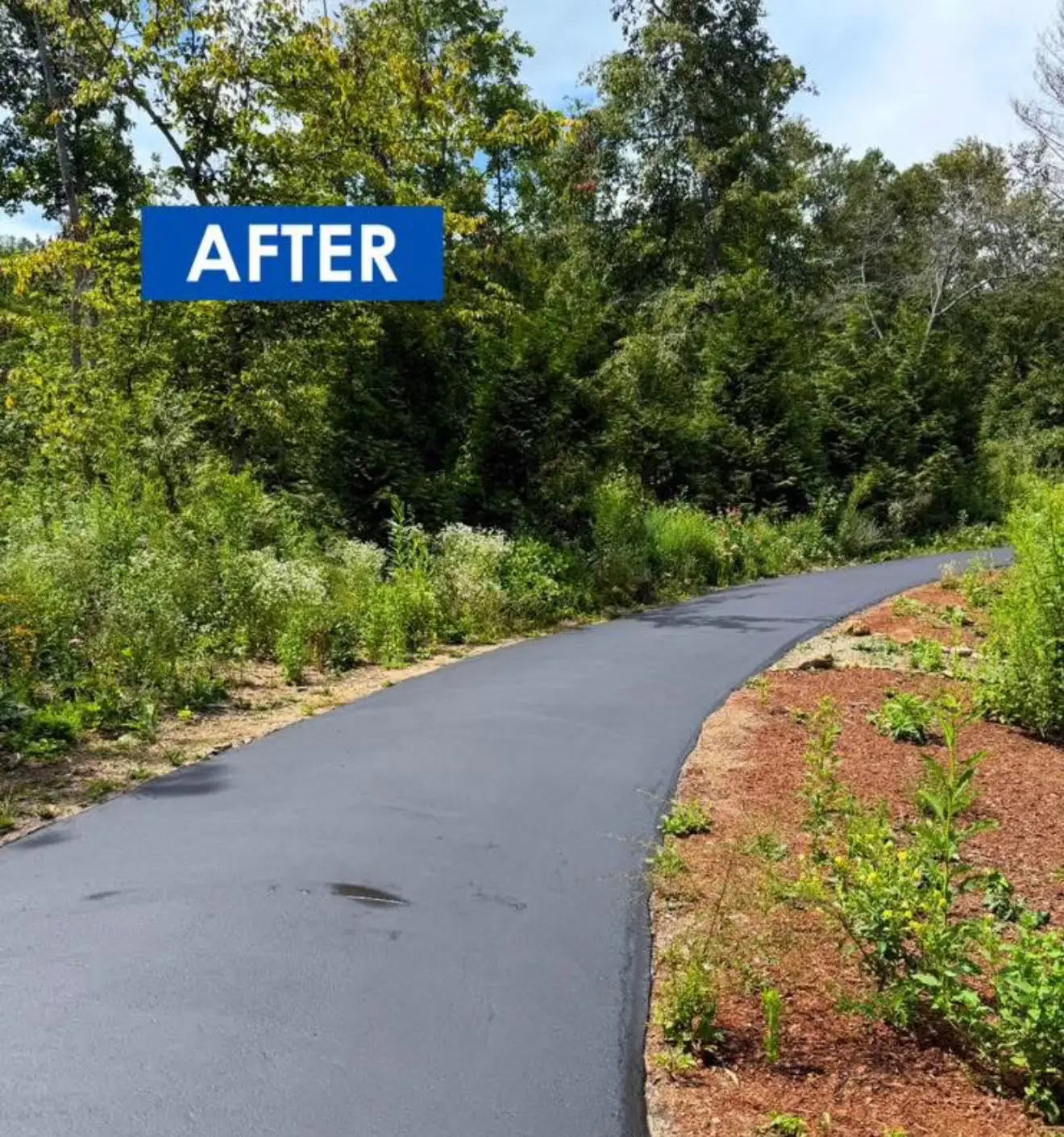 Residential driveway sealcoating with a rich black finish on a Charlotte NC neighborhood home